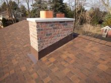 Asphalt shingle roofing and chimney flashing.